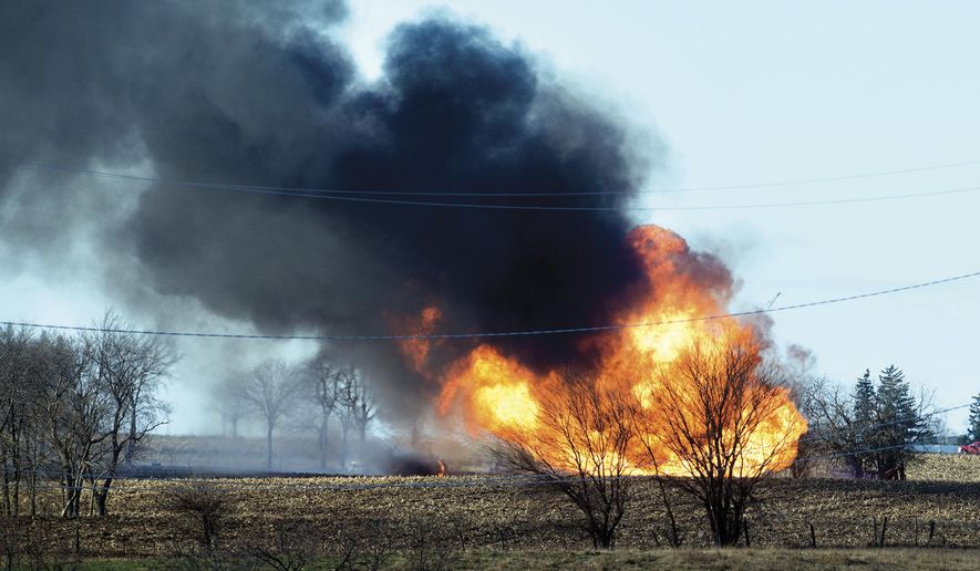 Fire rages at the scene of a natural gas pipeline explosion that sent flames and dark smoke into the air Tuesday, Dec. 5, 2017, outside of Dixon, Ill. The Lee County Sheriff's Department says the explosion happened on a farm near Nachusa. The Illinois State Fire Marshal's Office also said that it has investigators at the scene. (Alex T. Paschal /The Telegraph via AP)