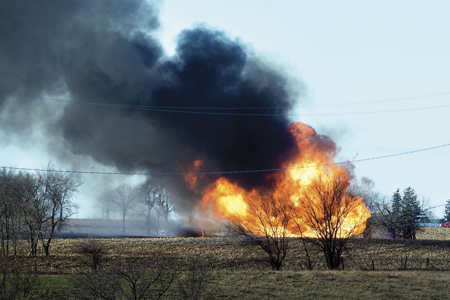Fire rages at the scene of a natural gas pipeline explosion that sent flames and dark smoke into the air Tuesday, Dec. 5, 2017, outside of Dixon, Ill. The Lee County Sheriff's Department says the explosion happened on a farm near Nachusa. The Illinois State Fire Marshal's Office also said that it has investigators at the scene. (Alex T. Paschal /The Telegraph via AP)