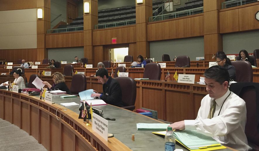 FILE - In this Feb. 3, 2016 file photo, legislative clerks in the New Mexico Senate load binders with new bills at the state capitol in Santa Fe, N.M. The New Mexico Statehouse has long been a place where women experience sexual harassment and that abuse often goes unchecked or unreported, according to female lobbyists and elected officials Democratic consultant Heather Brewer told The Associated Press on Monday, Dec. 4, 2017, that the harassment at the New Mexico Statehouse ranged from groping to propositions for sex. (AP Photo/Morgan Lee, File)