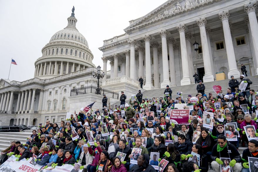 Demonstrators sit on the Senate steps before they are arrested outside of the U.S. Capitol during an immigration rally in support of the Deferred Action for Childhood Arrivals (DACA), and Temporary Protected Status (TPS), programs, on Capitol Hill, Wednesday, Dec. 6, 2017, in Washington. (AP Photo/Andrew Harnik) **FILE**