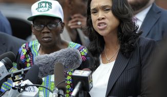 FILE - In a Wednesday, July 27, 2016 file photo, Baltimore State&#39;s Attorney Marilyn Mosby, right, holds a news conference near the site where Freddie Gray was arrested after her office dropped the remaining charges against three Baltimore police officers awaiting trial in Gray&#39;s death, in Baltimore.  The 4th U.S. Circuit Court of Appeals will hear arguments Wednesday, Dec. 6, 2017, in Mosby’s bid to overturn a decision from a judge who ruled that parts of the lawsuit filed against Mosby by five Baltimore police officers charged in the death of Freddie Gray can move forward. (AP Photo/Steve Ruark, File)