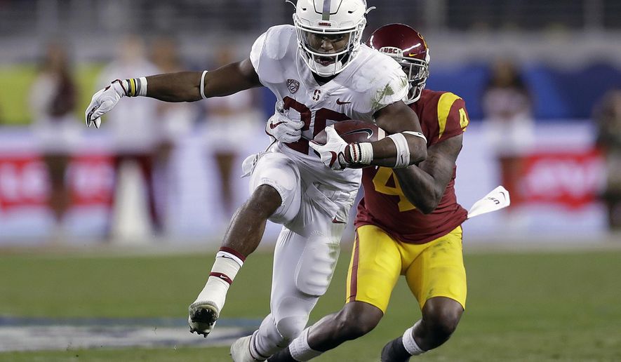 FILE - In this Dec. 1, 2017, file photo, Stanford running back Bryce Love (20) runs in front of Southern California safety Chris Hawkins (4) during the first half of the Pac-12 Conference championship NCAA college football game in Santa Clara, Calif. Love, Louisville's Lamar Jackson and Oklahoma's Baker Mayfield were chosen as finalists for the Heisman Trophy on Monday, Dec. 4, 2017. (AP Photo/Marcio Jose Sanchez, File)