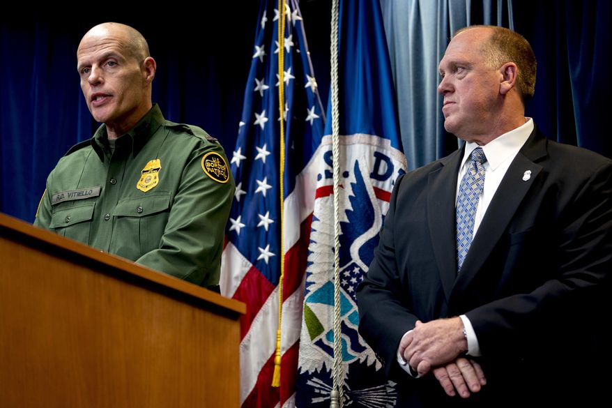 U.S. Customs and Border Protection Acting Deputy Commissioner Ronald Vitiello, left, accompanied by Acting Director for U.S. Immigration and Customs Enforcement Thomas Homan, right, speaks at a Department of Homeland Security news conference at the Ronald Reagan Building in Washington, Tuesday, Dec. 5, 2017, to announce end-of-year numbers regarding immigration enforcement. (AP Photo/Andrew Harnik)