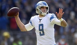 FILE - In this Dec. 3, 2017, file photo, Detroit Lions quarterback Matthew Stafford throws to a receiver in the first half of an NFL football game against the Baltimore Ravens, in Baltimore. Stafford was expected to test three banged-up fingers on his throwing hand in practice in the hopes of playing Sunday at Tampa Bay. Stafford’s right hand was stepped on in his last game, a loss at Baltimore that knocked him out of the game and put his team’s playoff outlook in peril. (AP Photo/Gail Burton, File)