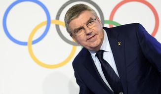 International Olympic Committee (IOC) president Thomas Bach, from Germany speaks during a media conference after the second day of the executive board meeting of the International Olympic Committee (IOC), in Lausanne, Switzerland, Wednesday, Dec. 6, 2017.  The International Olympic Committee on Tuesday banned the Russian Olympic team from the upcoming South Korea games as punishment for doping violations at the 2014 Sochi Olympics.(Laurent Gillieron/dpa via AP)