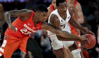 Syracuse guard Frank Howard (23) strips the ball from Connecticut guard Christian Vital (1) during the first half of an NCAA college basketball game, Tuesday, Dec. 5, 2017, in New York. (AP Photo/Julie Jacobson)