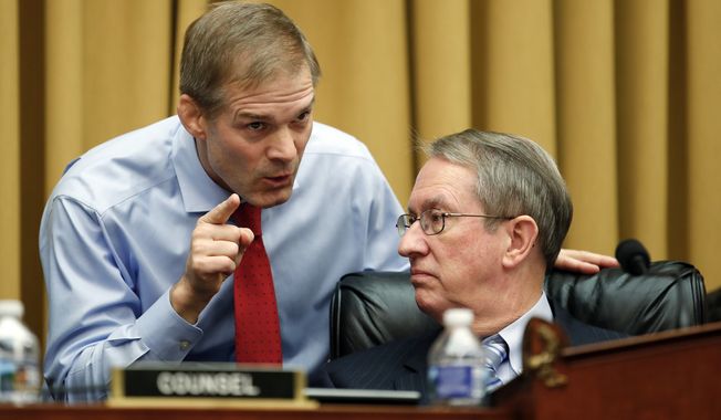 House Judiciary Committee Chairman Bob Goodlatte, R-Va., right, and committee member Rep. Jim Jordan, R-Ohio, talk as FBI Director Christopher Wray testifies during a House Judiciary hearing on Capitol Hill in Washington, Thursday, Dec. 7, 2017, on oversight of the Federal Bureau of Investigation. (AP Photo/Carolyn Kaster)