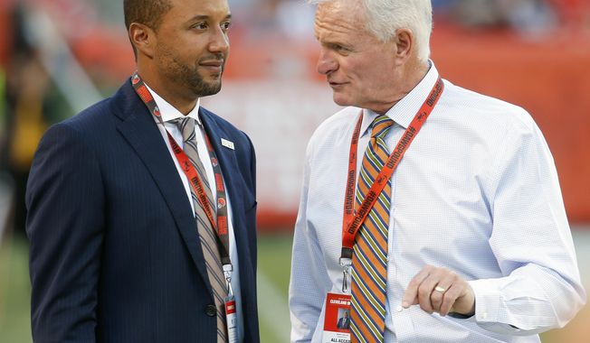 FILE - In this Aug. 18, 2016, file photo, Sashi Brown, acting executive vice president of football operations for the Cleveland Browns, left, speaks with Browns&#x27; owner Jimmy Haslam during practice before an NFL preseason football game against the Atlanta Falcons, in Cleveland. A person familiar with the decisions says the Cleveland Browns have fired Sashi Brown, the club’s vice president of football operations. Brown, who was named the team’s top executive by owners Dee and Jimmy Haslam during an overhaul following the 2015 season, was relieved of his duties on Thursday, Dec. 7, 2017, said the person who spoke to the Associated Press on condition of anonymity because the team has not announced the move. (AP Photo/Ron Schwane)