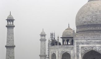 In this Tuesday, Dec. 5, 2017, photo, Indian workers clean the discoloration of the Taj Mahal caused by environmental pollution in Agra, India. Authorities in India are trying to figure out how workers will scale the Taj Mahal’s majestic but delicate dome as they complete the first thorough cleaning of the World Heritage site since it was built 369 years ago. Work on the mausoleum’s minarets and walls is almost finished, after workers began the makeover in mid-2015. They’ve been using a natural mud paste to remove yellow discoloration and return the marble to its original brilliant white. Called fuller’s earth, it’s the same clay that some people smother on their skin as a beauty treatment. (AP Photo/Manish Swarup)