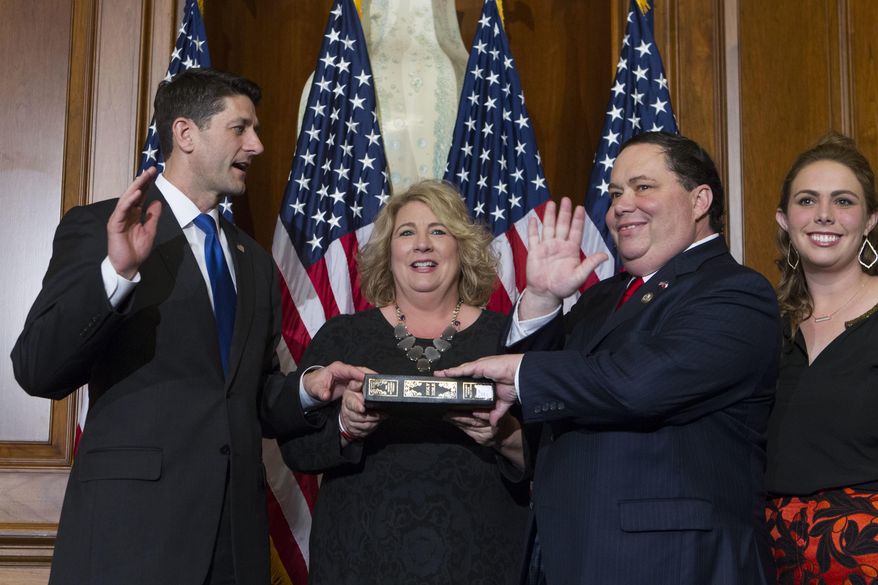 FILE - In this Jan. 3, 2017, file photo, House Speaker Paul Ryan of Wis. administers the House oath of office to Rep. Blake Farenthold, R-Texas, during a mock swearing in ceremony on Capitol Hill in Washington. The House Ethics Committee said Dec. 7 it is expanding its investigation into sexual harassment allegations against Farenthold. The committee said it will investigate whether Farenthold sexually harassed a former member of his staff and retaliated against her for complaining. The committee also said the panel would review allegations that Farenthold made inappropriate statements to other members of his official staff. ( AP Photo/Jose Luis Magana, File)