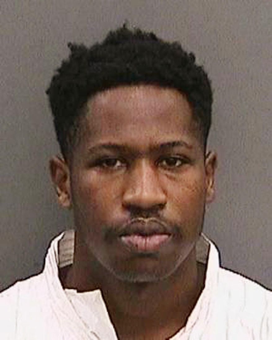 FILE - This file booking photo provided by the Tampa Police Department, Fla., on Wednesday, Nov. 29, 2017, shows Howell Emanuel Donaldson, the suspect in a string of four slayings that terrorized a Tampa neighborhood. The parents of Donaldson will go before a judge Thursday, Dec. 7, 2017, after refusing to answer questions about their son. The Tampa Bay Times reports investigators wanted to question Howell Donaldson Jr. and Rosita Donaldson on Tuesday about Howell Emanuel Donaldson III’s background, developmental history, gun possession and state of mind. But they refused, revealing only the names, addresses and birth dates of family members. (Tampa Police Department via AP, File)