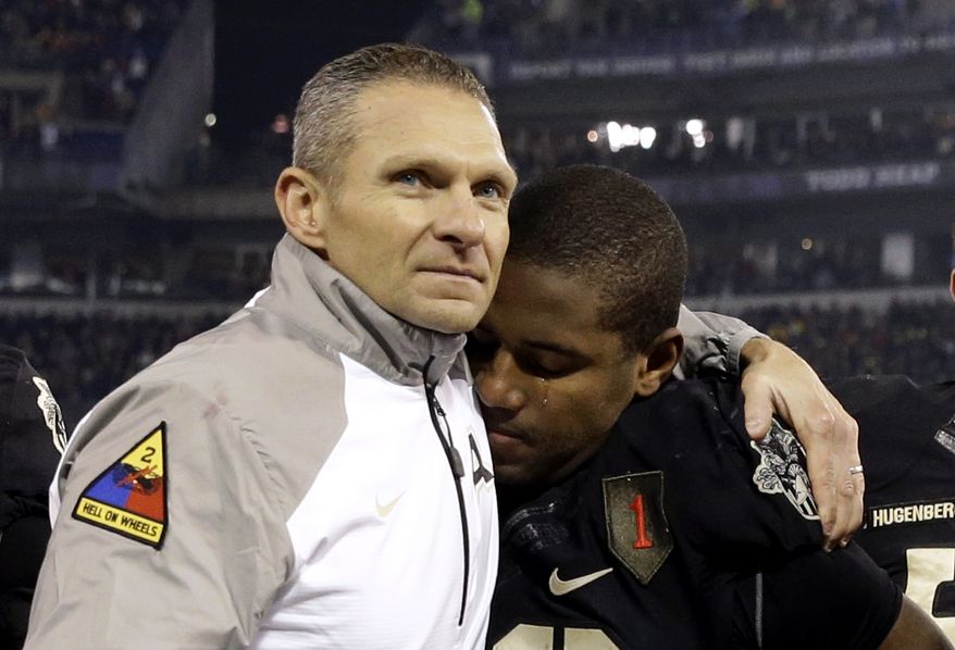 FILE - In this Dec. 13, 2014, file photo, Army head coach Jeff Monken, left, embraces running back Larry Dixon after losing 17-10 to Navy in an NCAA college football game, in Baltimore. Monkens second season at Army in 2015 ended with 10 losses and a record 14th straight defeat to Navy. While it pointed to more of the same for a struggling program, Monken was confident a West Point turnaround was imminent thanks to successful recruiting and the number of close losses. Monken was proven right. (AP Photo/Patrick Semansky, File)