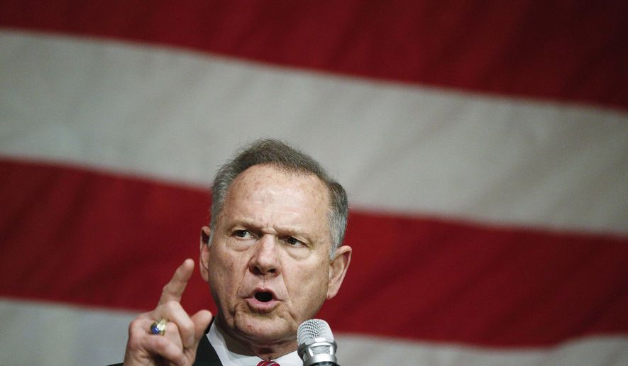 FILE - In this Dec. 5, 2017 photo, former Alabama Chief Justice and U.S. Senate candidate Roy Moore speaks at a campaign rally, in Fairhope Ala. Write-in votes could help decide Alabama’s Senate race between Moore and Democrat Doug Jones. Sculptor Lee Busby is running as a write-in along with several others, and University of Alabama football coaches like Nick Saban often get write-in votes in state elections.  (AP Photo/Brynn Anderson, File)
