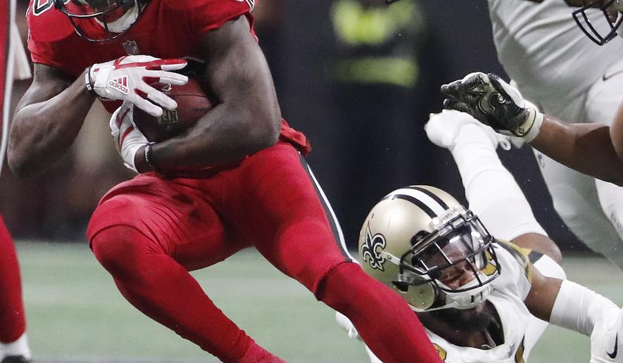 New Orleans Saints free safety Vonn Bell (48) Atlanta Falcons running back Tevin Coleman (26) runs past during the second half of an NFL football game, Thursday, Dec. 7, 2017, in Atlanta. (AP Photo/David Goldman)