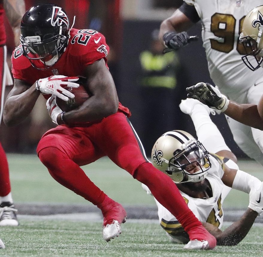 New Orleans Saints free safety Vonn Bell (48) Atlanta Falcons running back Tevin Coleman (26) runs past during the second half of an NFL football game, Thursday, Dec. 7, 2017, in Atlanta. (AP Photo/David Goldman)