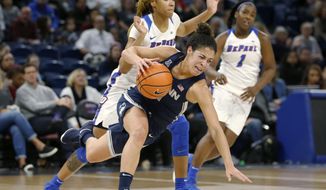Connecticut guard Kia Nurse, front, is tripped by DePaul forward Mart&#x27;e Grays during the first half of an NCAA college basketball game Friday, Dec. 8, 2017, in Chicago. (AP Photo/Charles Rex Arbogast)