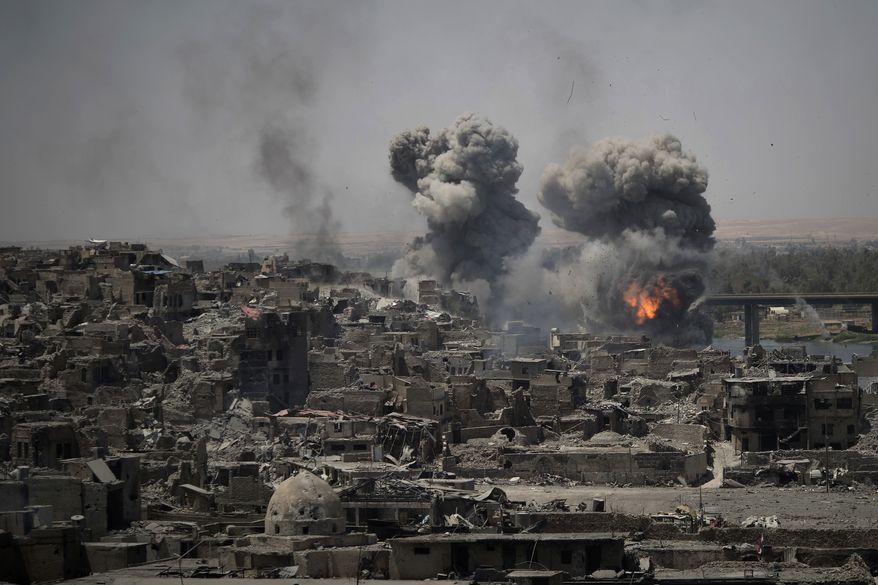 In this July 11, 2017, file photo, airstrikes target Islamic State positions on the edge of the Old City in Mosul, Iraq. Iraq said Saturday, Dec. 9, 2017, that its war on the Islamic State is over after more than three years of combat operations drove the extremists from all of the territory they once held. Prime Minister Haider al-Abadi announced Iraqi forces were in full control of the country&#39;s border with Syria. (AP Photo/Felipe Dana, File)