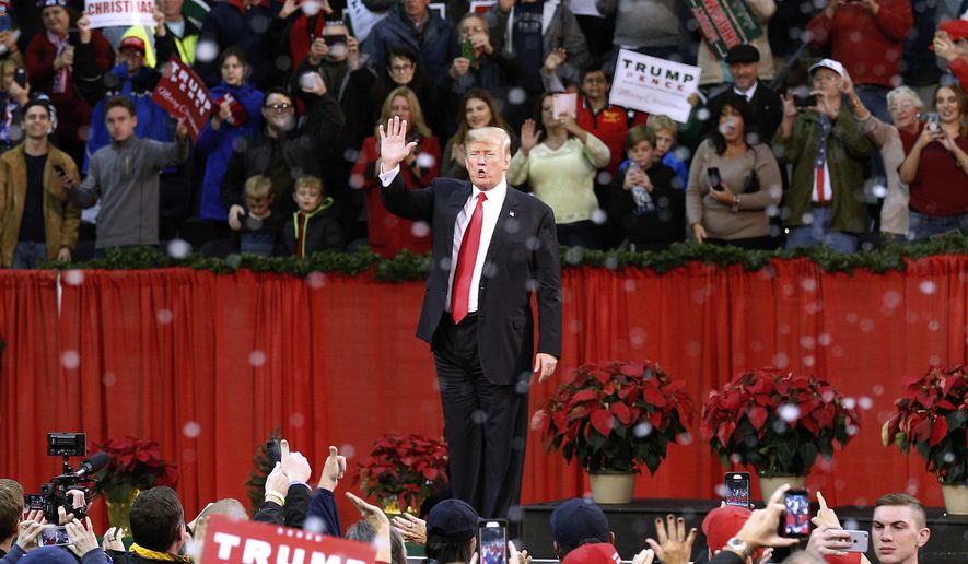 President Donald Trump waves to supporters after a rally in Pensacola, Fla., Friday, Dec. 8, 2017. (AP Photo/Jonathan Bachman)