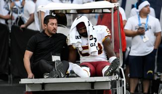 Washington Redskins linebacker Zach Brown leaves after spraining his right foot Sunday. &quot;That field&#x27;s horrible,&quot; Brown said of a StubHub Center made for soccer. (Associated Press)