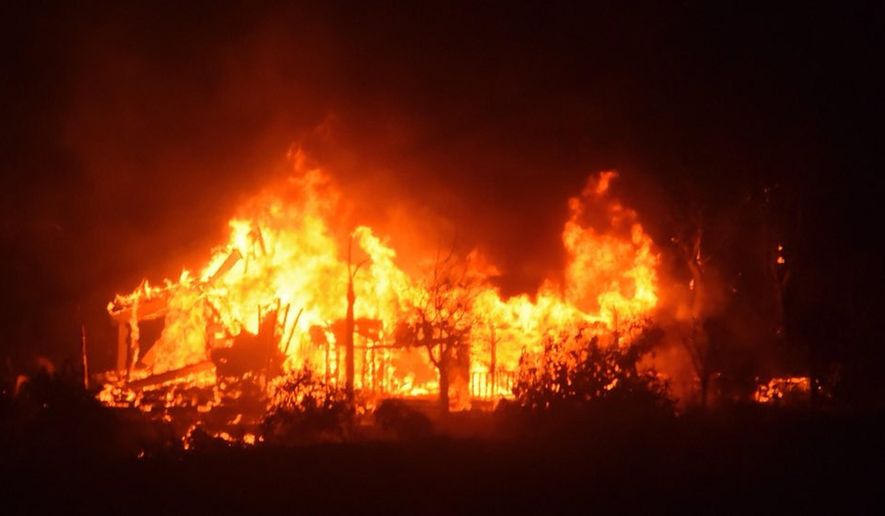 In this Sunday, Dec. 10, 2017 photo released by Santa Barbara County Fire Department, a home burns early Sunday morning off Gobernador Canyon Road in Carpinteria, Calif. A flare-up on the western edge of Southern California's largest and most destructive wildfire sent residents fleeing Sunday, as wind-fanned flames churned through canyons and down hillsides toward coastal towns. Crews with help from water-dropping aircraft saved several homes as unpredictable gusts sent the blaze churning deeper into foothill areas northwest of Los Angeles that haven't burned in decades. New evacuations were ordered in Carpinteria, a seaside city in Santa Barbara County that has been under fire threat for days. (Mike Eliason/Santa Barbara County Fire Department via AP)