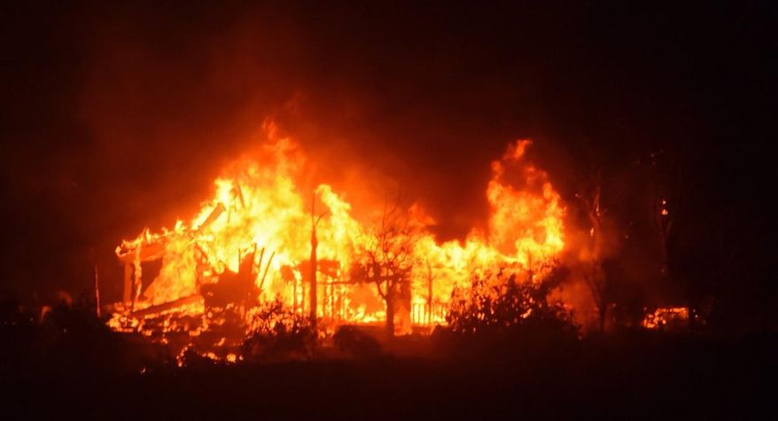 In this Sunday, Dec. 10, 2017 photo released by Santa Barbara County Fire Department, a home burns early Sunday morning off Gobernador Canyon Road in Carpinteria, Calif. A flare-up on the western edge of Southern California's largest and most destructive wildfire sent residents fleeing Sunday, as wind-fanned flames churned through canyons and down hillsides toward coastal towns. Crews with help from water-dropping aircraft saved several homes as unpredictable gusts sent the blaze churning deeper into foothill areas northwest of Los Angeles that haven't burned in decades. New evacuations were ordered in Carpinteria, a seaside city in Santa Barbara County that has been under fire threat for days. (Mike Eliason/Santa Barbara County Fire Department via AP)