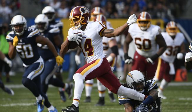 Washington Redskins wide receiver Ryan Grant gets away from Los Angeles Chargers safety Tre Boston, below, during the first half of an NFL football game Sunday, Dec. 10, 2017, in Carson, Calif. (AP Photo/Denis Poroy) **FILE**