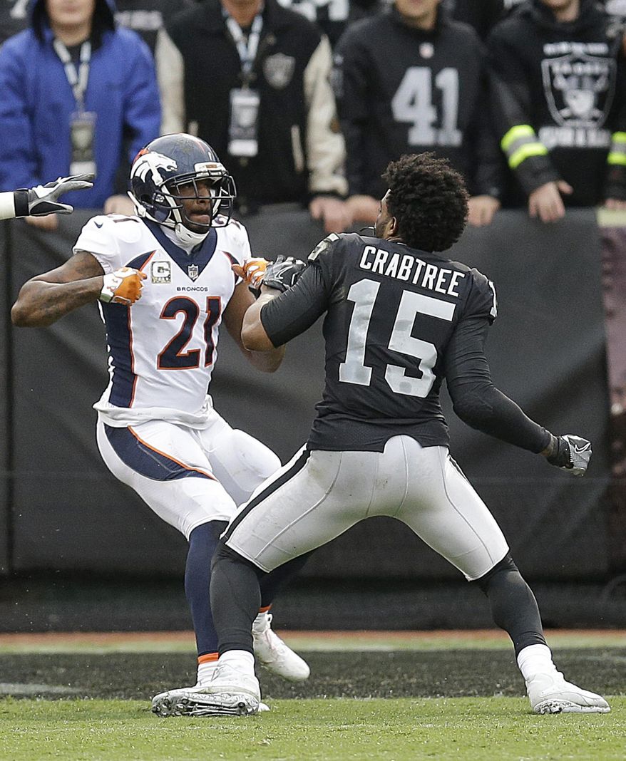 FILE - In this Nov. 26, 2017, file photo, Denver Broncos cornerback Aqib Talib (21) fights Oakland Raiders wide receiver Michael Crabtree (15) during the first half of an NFL football game in Oakland, Calif. Sometimes, it seems, conflicts between cornerbacks and wideouts are simply unavoidable. It is a unique dynamic in NFL games week after week: On play after play, CBs and WRs match up 1-on-1, with plenty of grabbing and shoving and, yes, yapping mixed in. (AP Photo/Ben Margot, File) **FILE**