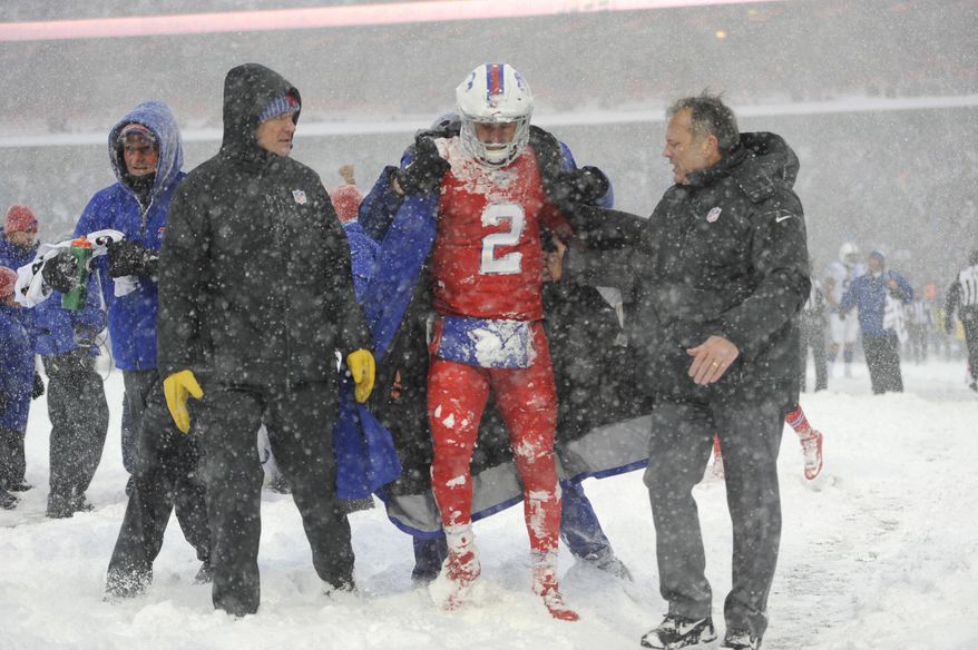 Buffalo Bills quarterback Nathan Peterman, center, is helped to the sidelines during the second half of an NFL football game against the Indianapolis Colts, Sunday, Dec. 10, 2017, in Orchard Park, N.Y. (AP Photo/Adrian Kraus)