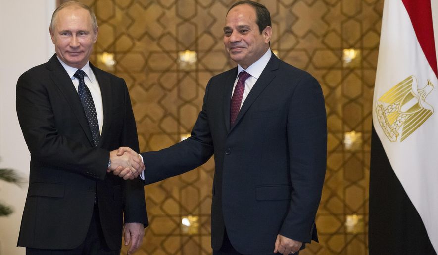 Russian President Vladimir Putin, left, and Egyptian President Abdel-Fattah El-Sissi, shake hands during their meeting in Cairo, Egypt, Monday, Dec. 11, 2017. (AP Photo/Alexander Zemlianichenko/ pool photo via AP)