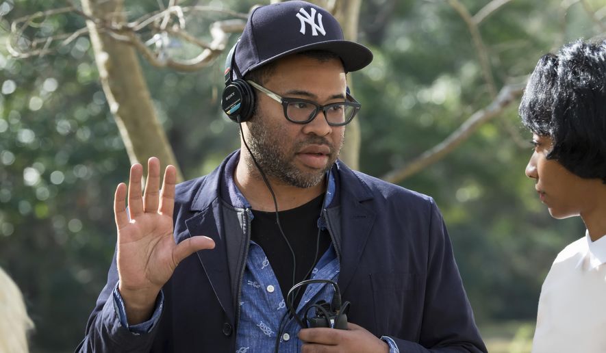 This image released by Universal Pictures shows director Jordan Peele on the set of "Get Out." Peele failed to get a Golden Globe nomination for best director or screenplay for his critically acclaimed film on Monday, Dec. 11, 2017. (Justin Lubin/Universal Pictures via AP)
