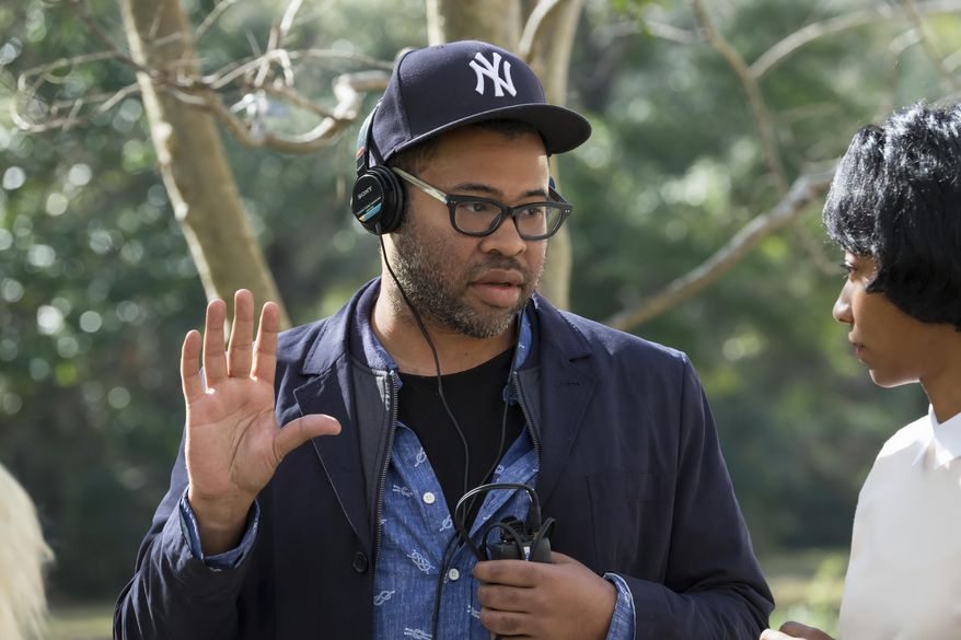 This image released by Universal Pictures shows director Jordan Peele on the set of "Get Out." Peele failed to get a Golden Globe nomination for best director or screenplay for his critically acclaimed film on Monday, Dec. 11, 2017. (Justin Lubin/Universal Pictures via AP)