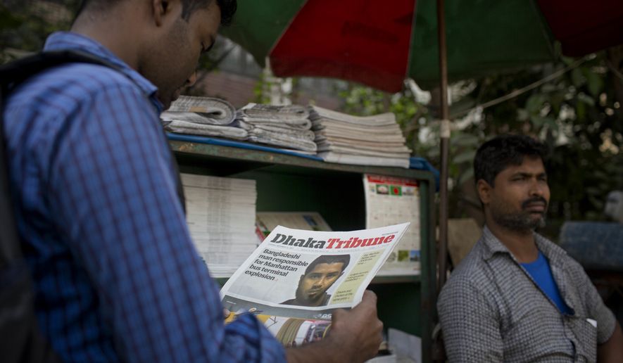 A Bangladeshi man reads a national newspaper that features news of 27-year-old Bangladeshi man Akayed Ullah, in Dhaka, Bangladesh, Tuesday, Dec. 12, 2017. Bangladesh counterterrorism officers are questioning the wife and other relatives of Ullah, who is accused of carrying out a bomb attack in New York City&#39;s subway system, officials said Tuesday. (AP Photo/A.M. Ahad)