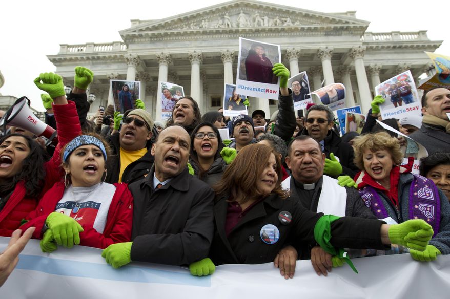 In this Dec. 6, 2017 photo, Rep. Luis Gutierrez D-Ill., third from left, along with other demonstrators protest outside of the U.S. Capitol in support of the Deferred Action for Childhood Arrivals (DACA), and Temporary Protected Status (TPS), programs, during an rally on Capitol Hill in Washington. House and Senate Democrats stand divided over whether to fight now or later about the fate of some 800,000 young immigrants who came to the U.S. illegally as children. ( AP Photo/Jose Luis Magana) **FILE**