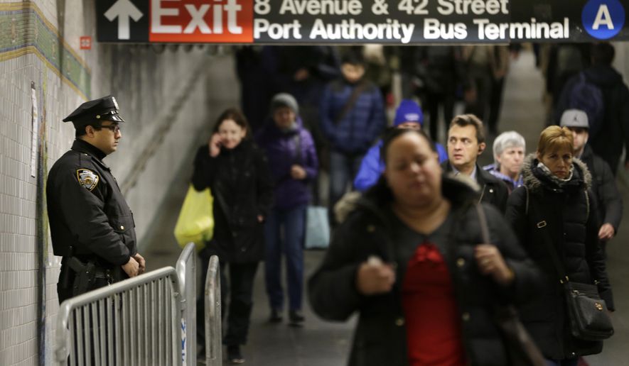 A police officer stands in the passageway connecting New York City&#39;s Port Authority bus terminal and the Times Square subway station Tuesday, Dec. 12, 2017, near the site of Monday&#39;s explosion. Commuters returning to New York City&#39;s subway system on Tuesday were met with heightened security a day after a would-be suicide bomber&#39;s rush-hour blast failed to cause the bloodshed he intended. (AP Photo/Seth Wenig)
