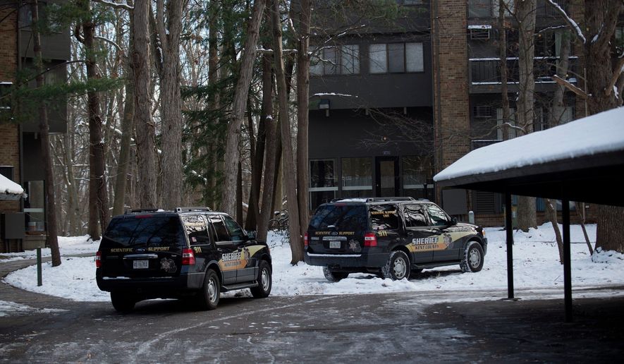 Police investigate the scene where authorities say a man was shot and wounded by a police officer responding to a report of a domestic dispute at Ramblewood Apartments on Tuesday, Dec. 12, 2017, in Wyoming, Mich. (Neil Blake /The Grand Rapids Press via AP)