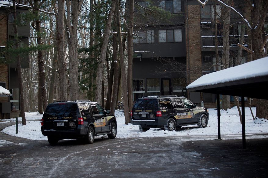 Police investigate the scene where authorities say a man was shot and wounded by a police officer responding to a report of a domestic dispute at Ramblewood Apartments on Tuesday, Dec. 12, 2017, in Wyoming, Mich. (Neil Blake /The Grand Rapids Press via AP)