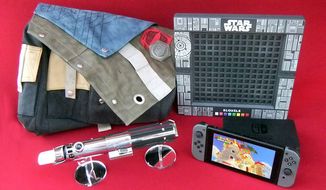 Gift ideas for gamers include the frontier bag from Activision&#39;s Destiny 2 Collectors Edition, a lightsaber from Lenovo&#39;s Star Wars: Jedi Challenges, Mattel&#39;s Star Wars Bloxels and Nintendo&#39;s Switch gaming system. (Photograph by Joseph Szadkowski / The Washington Times)