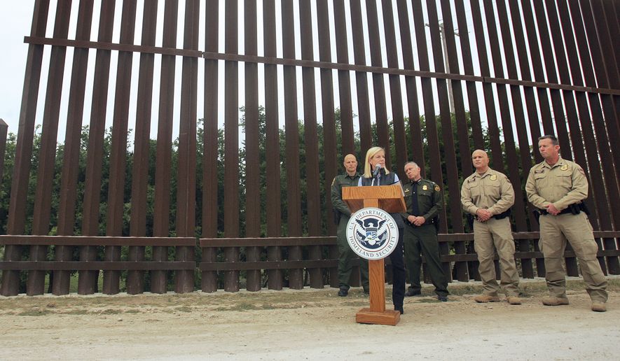 United States Department of Homeland Security Secretary Kirstjen Nielsen speaks to the local news media against the backdrop of the border wall, Wednesday, Dec 13, 2017, in Hidalgo, Texas. The new head of the U.S. Department of Homeland Security says she hopes construction on a border wall will begin soon. (Joel Martinez/The Monitor via AP)
