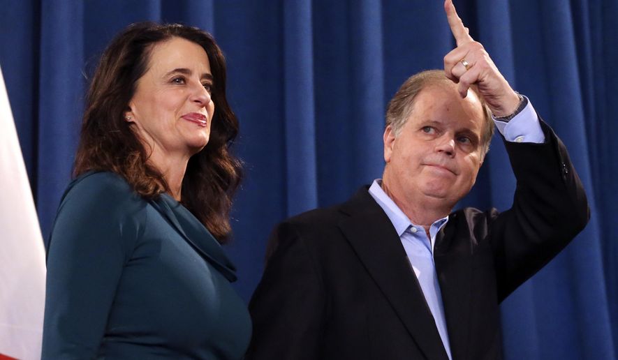 Democratic Sen.-elect Doug Jones waves to reporters as he and his wife Louise leave a news conference Wednesday, Dec. 13, 2017, in Birmingham, Ala. Weary national Republicans breathed a collective sigh of relief on Wednesday, a day after voters knocked out their own party&#x27;s scandal-plagued candidate in deep-red Alabama. (AP Photo/John Bazemore)