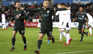 Manchester City&#x27;s David Silva, centre, scores his side&#x27;s first goal of the game against Swansea City, during their English Premier League soccer match at the Liberty Stadium in Swansea, England, Wednesday Dec. 13, 2017. (Nick Potts/PA via AP)