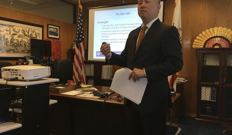 Assemblyman Phil Ting, D-San Francisco, presents the Assembly&#x27;s budget proposal in his office at the state Capitol in Sacramento, Calif., Wednesday, Dec. 13, 2017. California Assembly Democrats say they want to use the windfall from a growing economy to expand a tax credit for the working poor and extend health coverage to immigrants living in the country illegally. (AP Photo/Jonathan J. Cooper)