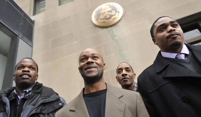 FILE - In this Jan. 17, 2012 file photo, Harold Richardson, left, Vincent Thames, second from left, Terrill Swift, and Michael Saunders, right, pose for a photo after a hearing in Chicago for the four men known as &amp;quot;the Englewood Four,&amp;quot; whose 1994 rape and murder convictions were overturned in November 2011. New DNA evidence linked another person to the crime. The Chicago City Council approved Wednesday, Dec. 13, 2017, a $31 million settlement to be shared by the men who each spent more than a decade in prison. The police misconduct settlement is one of the largest in the history of the city . (AP Photo/Paul Beaty, File)