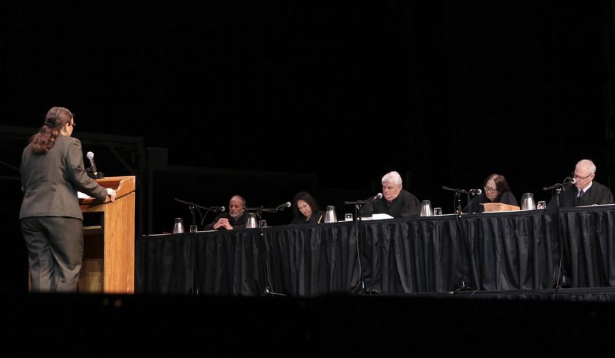 Attorney Rebecca Copeland, left, who is representing a divorced lesbian woman who wants to dissolve parental rights, argues in front of the Hawaii Supreme Court, Thursday, Dec. 14, 2017 in Kaneohe, Hawaii. National gay rights advocates are watching how the case plays out in Hawaii, likely the first such case before a state's highest court, experts say. A woman wants to sever her parental rights to a child her ex-wife gave birth to and is appealing a family court ruling denying that request. (AP Photo/Jennifer Sinco Kelleher)