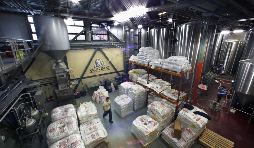 This Thursday, Nov. 16, 2017 photo shows energy efficient motion activated LED lights, along with window light, that illuminate the Smuttynose Brewery in Hampton, N.H. The brewhouse is taking advantage of special programs to use new technology to reduce its carbon footprint. (AP Photo/Robert F. Bukaty)