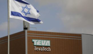 Israeli flag flies outside Teva Pharmaceutical facility building in Neot Hovav, Israel, Thursday, Dec. 14, 2017. Teva Pharmaceutical Industries Ltd., the world&#39;s largest generic drugmaker, says it is laying off 14,000 workers as part of a global restructuring. The company said Thursday that the layoffs represent over 25 percent of its global work force. (AP Photo/Tsafrir Abayov)