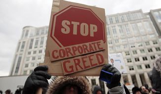 A woman hold a sign that reads &amp;quot;Stop Corporate Greed&amp;quot; during a protest at the Federal Communications Commission (FCC), in Washington, Thursday, Dec. 14, 2017, where the FCC is scheduled to meet and vote on net neutrality. The vote scheduled today at the FCC, could usher in big changes in how Americans use the internet, a radical departure from more than a decade of federal oversight. (AP Photo/Carolyn Kaster) **FILE**