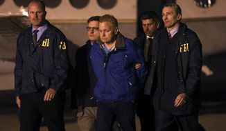 In a Tuesday, Dec. 5, 2017 file photo, fugitive lawyer Eric Conn is taken into custody by FBI agents on the tarmac at Blue Grass Airport in Lexington, Ky.  Conn is facing prosecution on charges he would have avoided if he had not vanished for six months to avoid prison. A federal prosecutor filed court papers signaling the government will try Conn on more than a dozen charges including mail fraud, wire fraud and money laundering. If convicted, Conn could spend the rest of his life in prison. (AP Photo/Matt Goins, File)