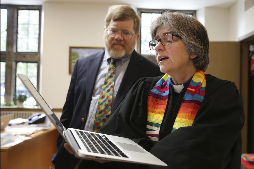 Rev. Carolyn Winfrey Gillette, co-pastor of Overbrook Presbyterian Church, sings one of her hymns as her husband and co-pastor, Rev. Bruce Gillette, listens in their office at Overbrook Presbyterian Church in Philadelphia on Nov. 7, 2017. With borrowed melodies often familiar to churchgoers, her spiritual deliberations on subjects from gun violence, health care and immigration to natural disasters and the environment have been sung around the world in sanctuaries, on college campuses, in Bible school classrooms, and during street protests. (David Maialetti/The Philadelphia Inquirer via AP)