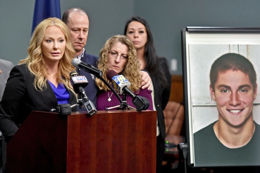 FILE – In this May 5, 2017, file photo, Centre County, Pa., District Attorney Stacy Parks Miller, left, announces findings an investigation into the death of Penn State University fraternity pledge Tim Piazza, seen in photo at right, as his parents, Jim and Evelyn Piazza, second and third from left, stand nearby during a news conference in Bellefonte, Pa. Parks is scheduled to release grand jury recommendations Friday, Dec. 15, 2017, on the fraternity culture at Penn State. (Abby Drey/Centre Daily Times via AP, File)