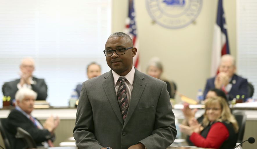 In this Thursday, Dec. 14, 2017 photo, Vernon Hale, deputy chief of police for the Dallas Police Department, receives applause after being confirmed as Galveston's new Police Chief by the city council, in Galveston, Texas. (Jennifer Reynolds /The Galveston County Daily News via AP)